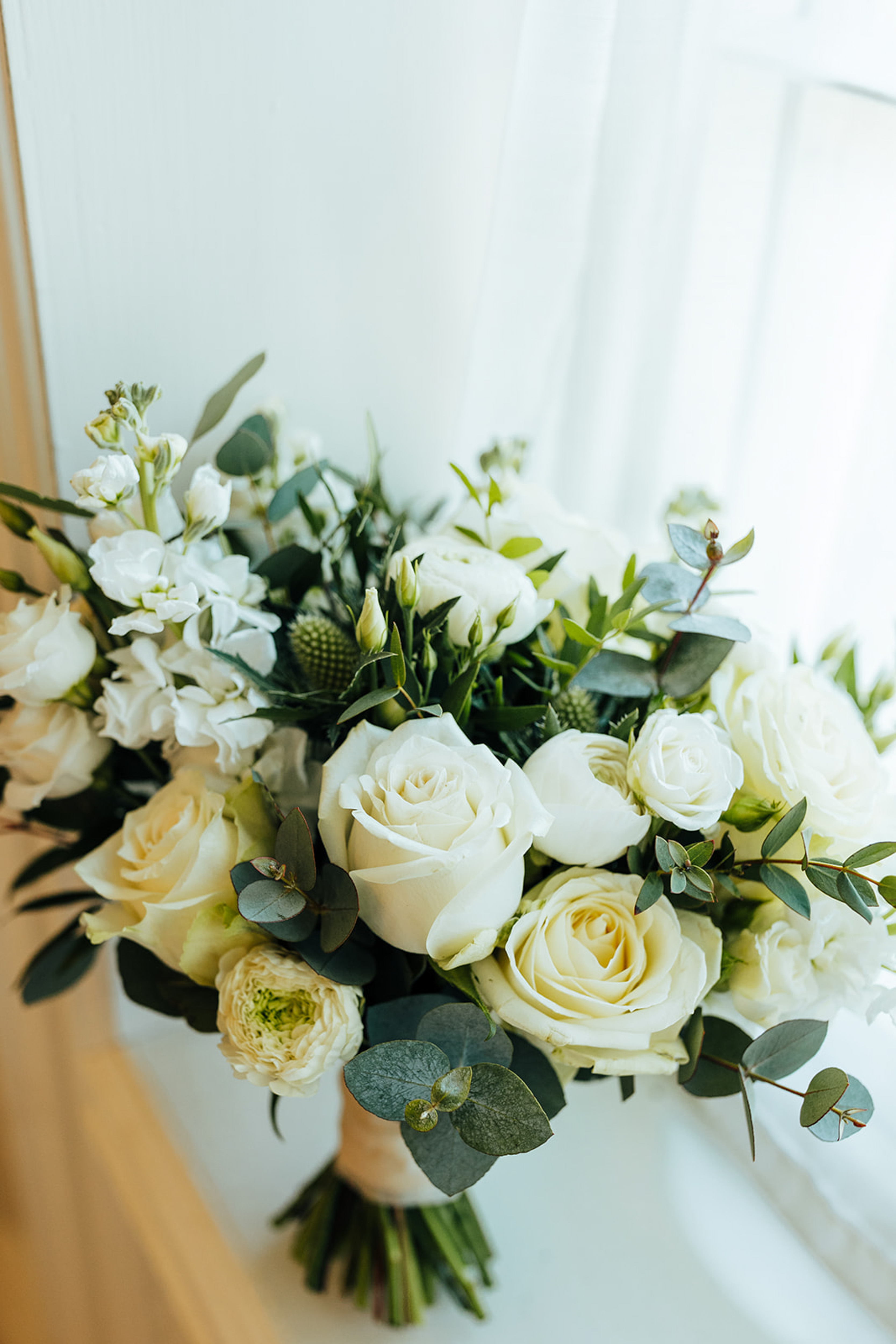 Minimal white and green bridal bouquet. Rushton Hall Wedding Photography. Documentary UK Wedding Photographer. Aimee Joy Photography.